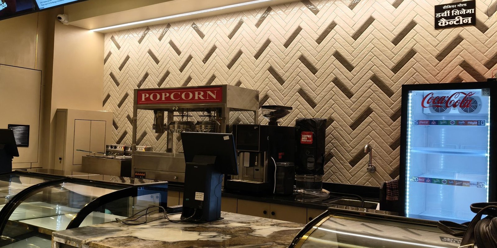 The Vox Talkies concession counter with popcorn machine and beverage cooler